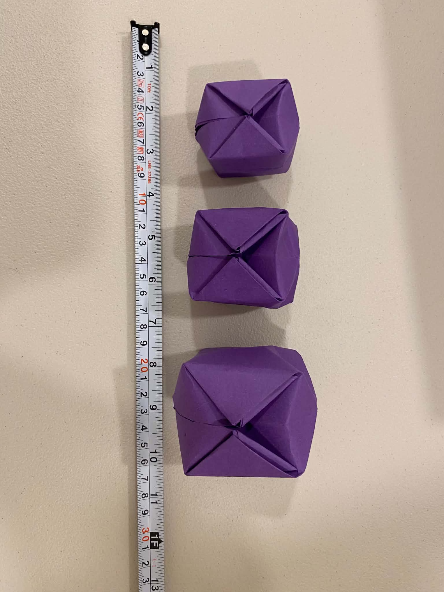 The three purple origami cubes used in the task.